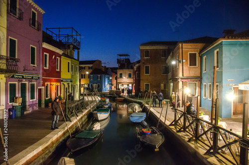 Colourfully painted houses facade on Burano island in evening, province of Venice, Italy © Mariana Ianovska