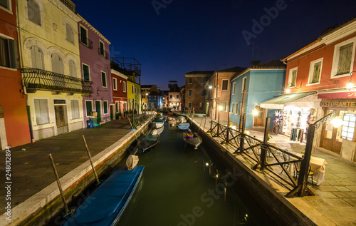 Colourfully painted houses facade on Burano island in evening, province of Venice, Italy © Mariana Ianovska