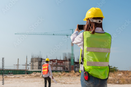 Engineers using mobile phone at construction site