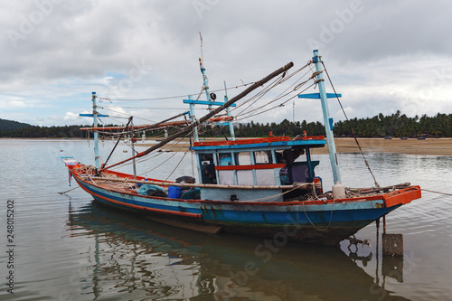 The old fishing boat during an outflow in Thailand.