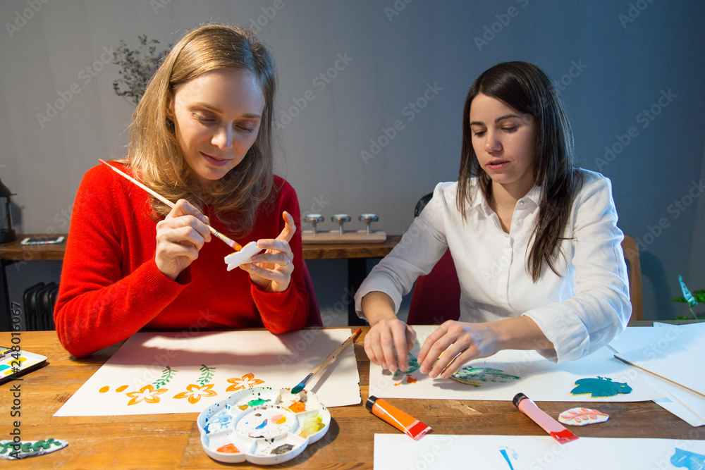 Fototapeta premium Two peaceful girls enjoying simple painting