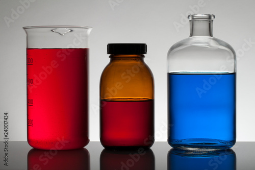 Liquid in laboratory bottles. Scientific biochemical laboratory. Colorful liquid.