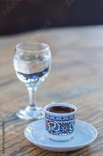 Fototapeta Naklejka Na Ścianę i Meble -  a сup of black coffee and a glass of clean water