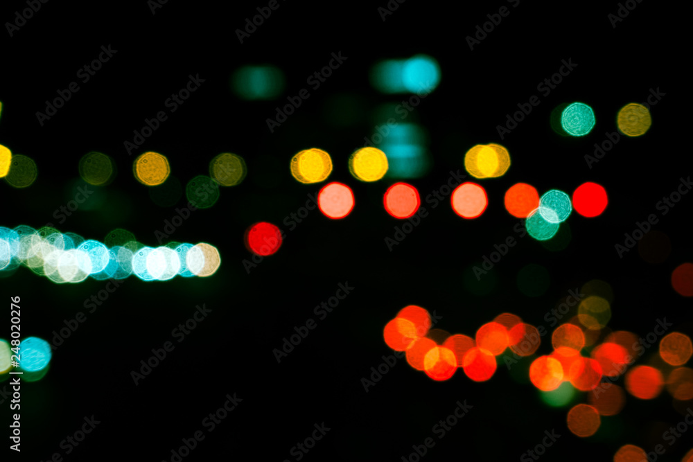 Fototapeta premium Abstract blurred background of city light. Out of focus traffic light background.