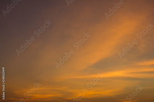 yellow orange clouds in a pink blue sunset sky