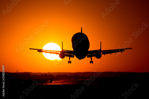 Beluga airplane landing at sunset