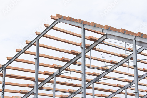 Part of the building structure of galvanized parts. Galvanized parts on a construction site in rainy weather. Waiting for the installation of metal structures. Galvanized metal is not exposed to corro