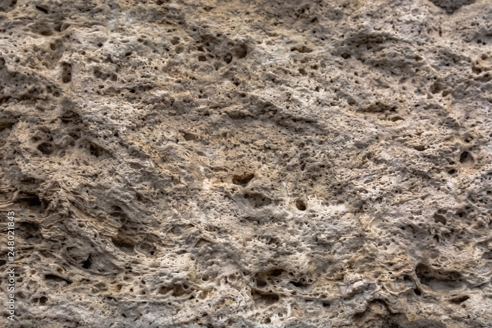 Textured uneven stone surface. Yellow limestone. Background image. Construction material. Textured uneven stone surface. Yellow limestone. Background image. Construction material.
