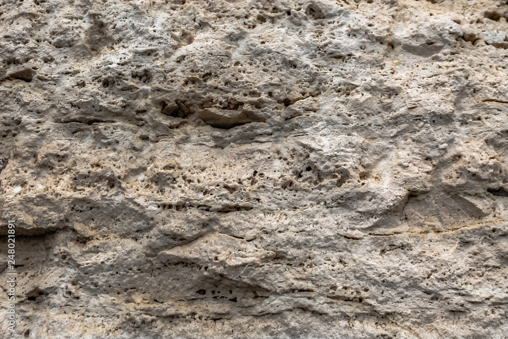 Textured uneven stone surface. Yellow limestone. Background image. Construction material. Textured uneven stone surface. Yellow limestone. Background image. Construction material.