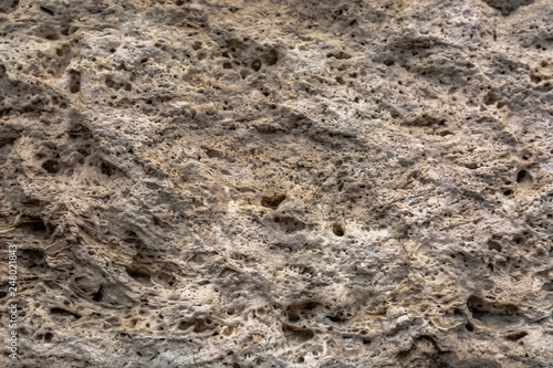 Textured uneven stone surface. Yellow limestone. Background image. Construction material.