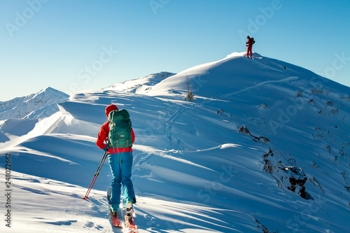Girl makes ski mountaineering alone toward the mountain pass in a nice track with sealskin © greenlex