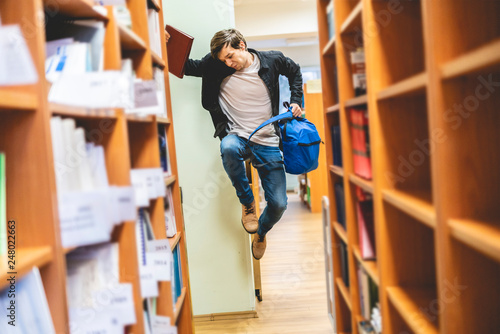 happy student jumping with books and backpack b