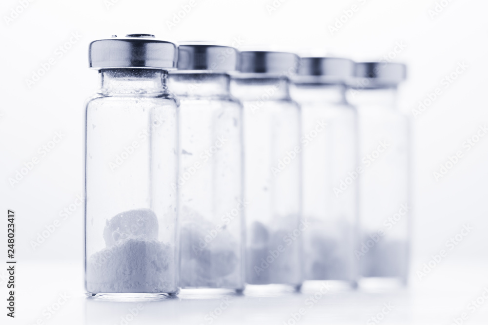 Bottles for injection with white powder on a white background Bottles for injection with white powder on a white background