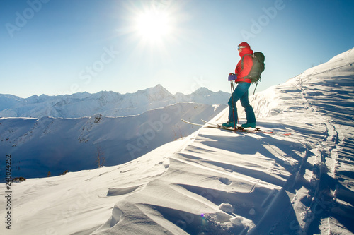 Girl makes ski mountaineering alone toward the mountain pass in a nice track with sealskin photo
