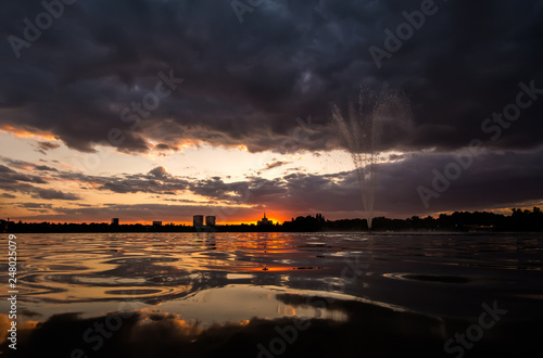 Bucharest sunset over Herastrau park lake , Europe modern city 