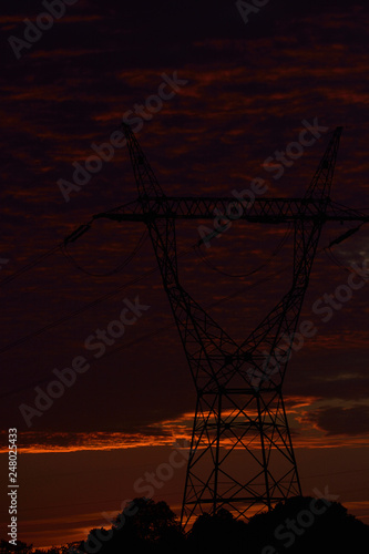 high voltage poles and sunset