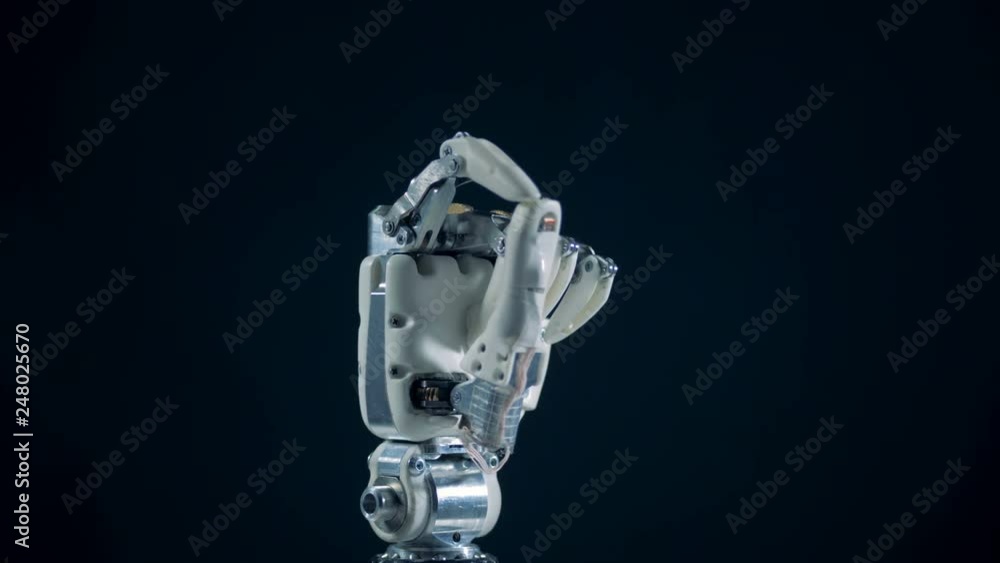 Fist of a robotic hand is moving its fingers Fist of a robotic hand is moving its fingers