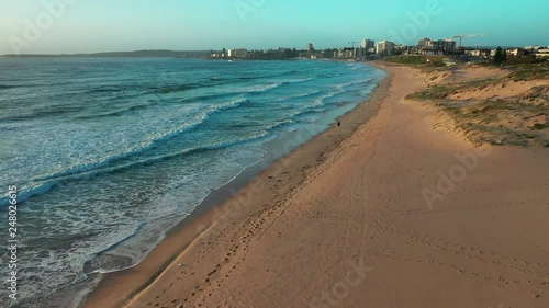 Flying over an empty beach on the northern coast of Sydney