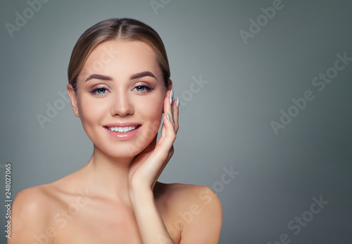 Young woman face. Healthy skin, cute smile. Perfect girl smiling. Facial treatment, skincare and cosmetology concept