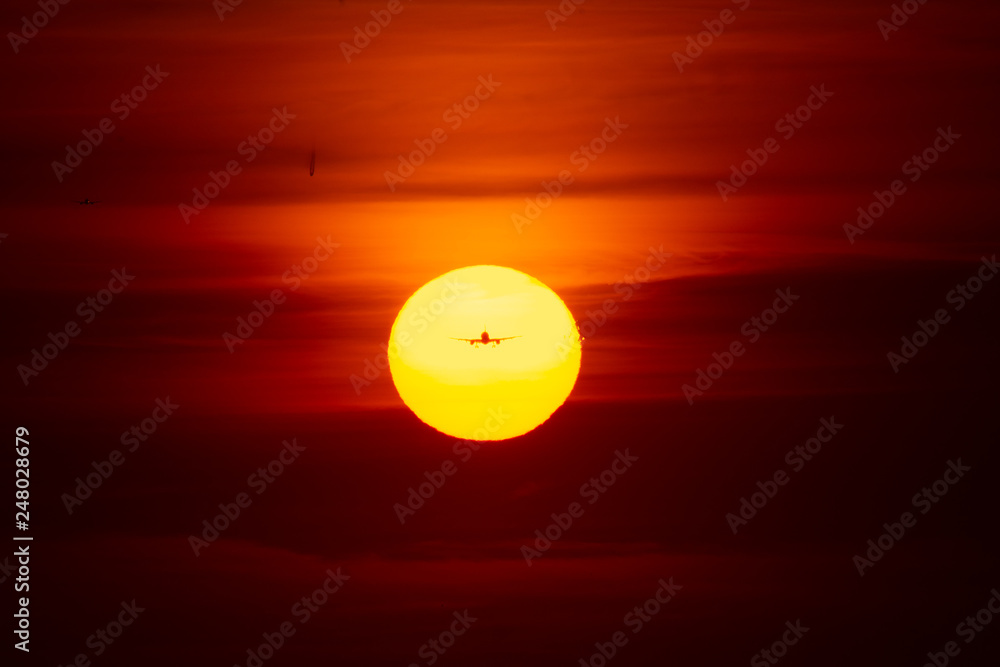 Silhouette of airplane in sunset landing on airport Silhouette of airplane in sunset landing on airport