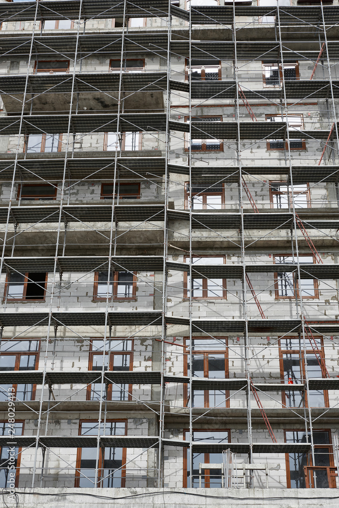 new building under construction, scaffolding and concrete