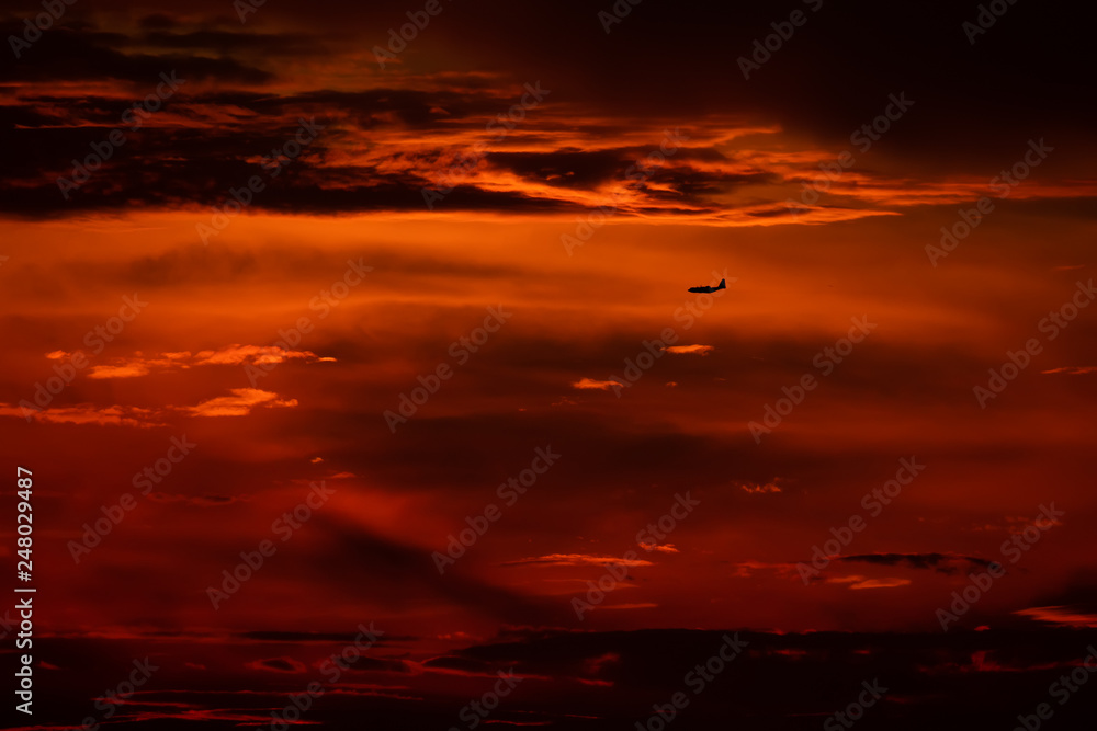 Silhouette of airplane taking of in the sunset 