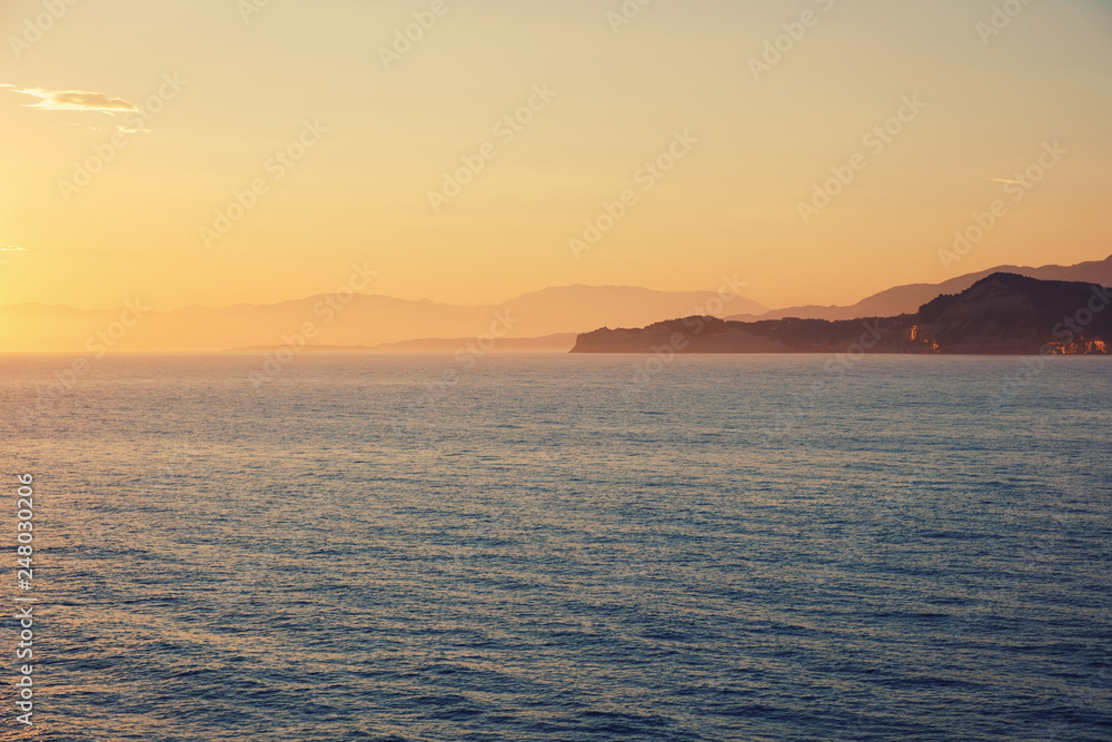 Amazing blue Ionian Sea at sunrise in Sidari holiday village on Corfu island