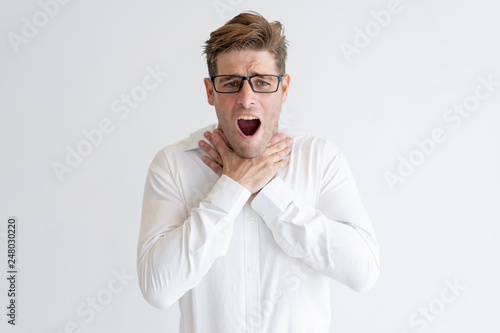 Frustrated man showing suffocation gesture photo