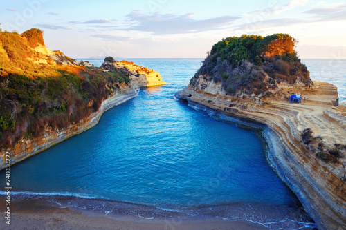 Famous Canal d'Amour beach with beautiful rocky coastline in amazing blue Ionian Sea at sunrise in Sidari holiday village on Corfu island
