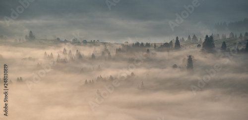 Bucovina landscape in autumn time with mist and sunrise in Romania 