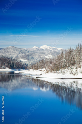  Beautiful peaceful lake in mountains in winter, nature landscape in Gorski kotar, Croatia 