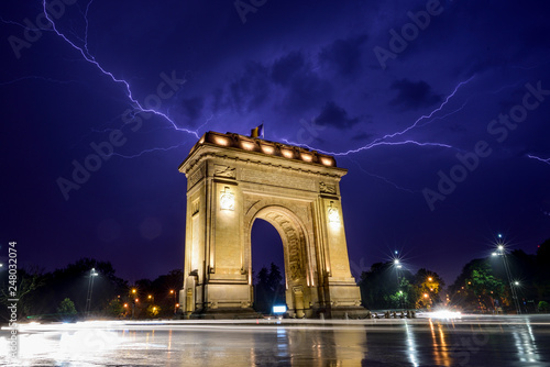 Canvas Print Lightning storm  in Bucharest city , Romania  with triumphal arch