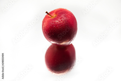 Red Apple isolated on white background with reflection. Fresh raw organic fruit.