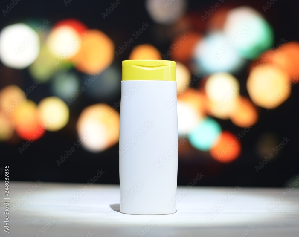 bottle with shampoo on blurry background bottle with shampoo on blurry background