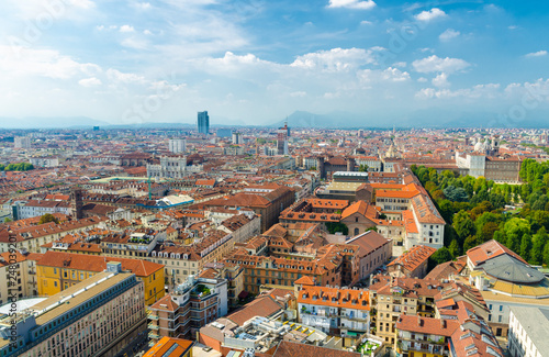 Aerial top panoramic view of Turin city historical centre, Royal Palace, Palazzo Carignano, San Lorenzo church, orange tiled roofs of buildings, sightseeings with Alps mountain range, Piedmont, Italy