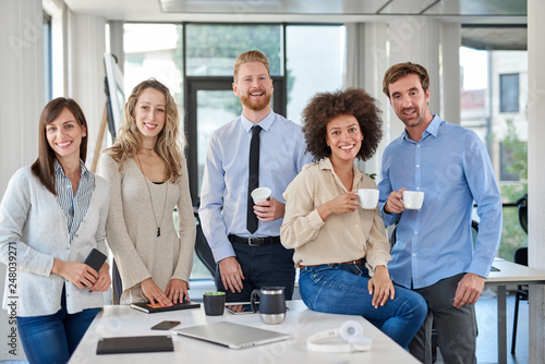 Vászonkép Cheerful group of business people posing in office