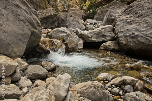 Crystal clear water of a cold mountain creek at rocky terrain of Samaria gorge  south west part of Crete island  Greece