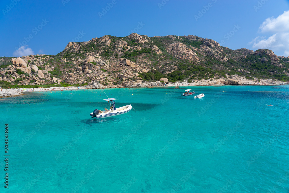 Yachts and boats anchored at beautiful beach of archipelago la Maddalena. Sardinia, Italy