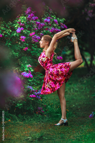 beautiful woman doing yoga outdoors On green grass © solstizia