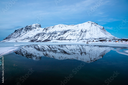 snowy mountains reflected in the lake at dusk, Lofoten Islands, Norway