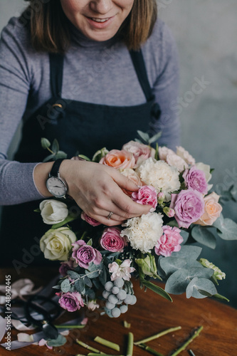 girl florist makes a beautiful bouquet