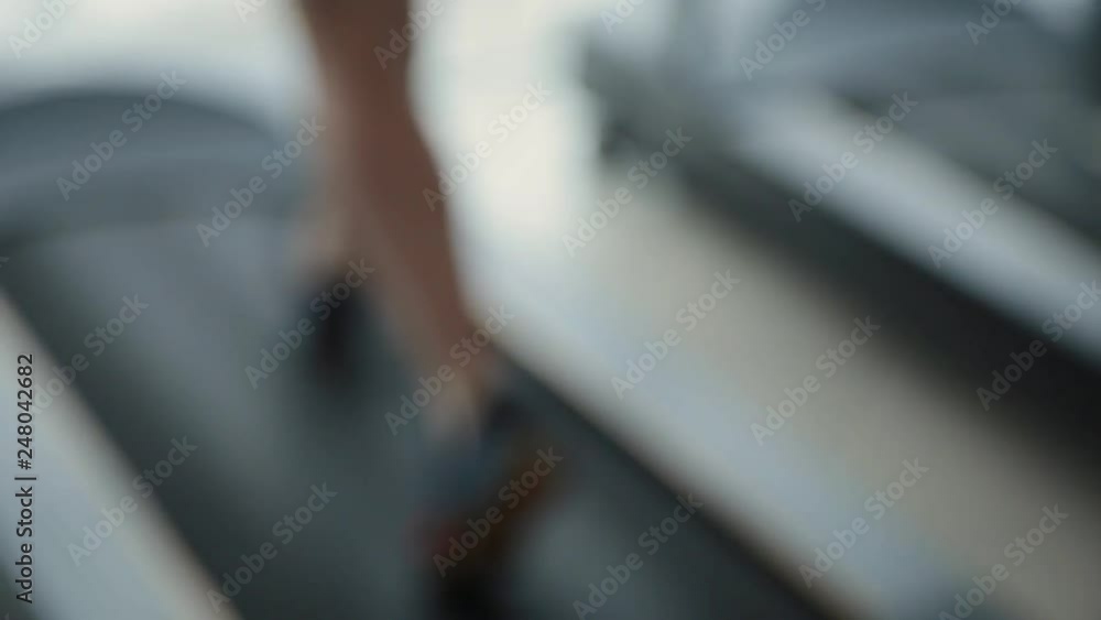 Blurred woman running on a treadmill at the gym. Blurred woman running on a treadmill at the gym.