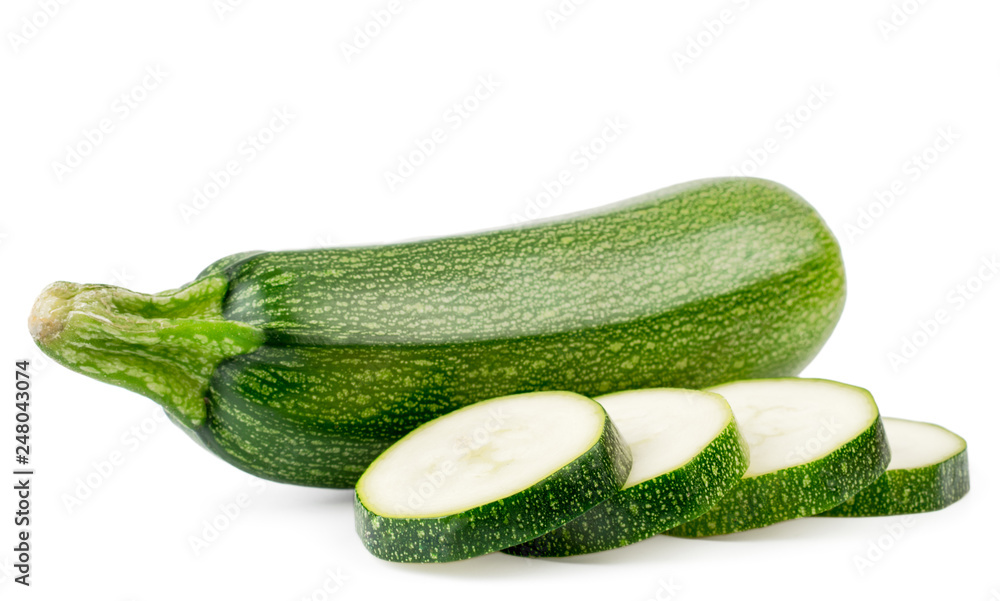 Fresh zucchini and sliced slices close up on a white. Isolated. Fresh zucchini and sliced slices close up on a white. Isolated.