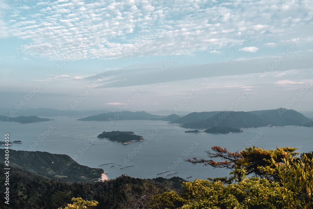 Beautiful view on trees and cloudy sky and pearl farms from Mount Misen at Miyajima island in Hiroshima