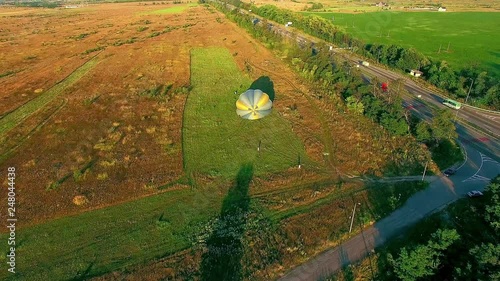 takeoff air balloon at sunset, air balloons start fly from grass field at summer sunset photo