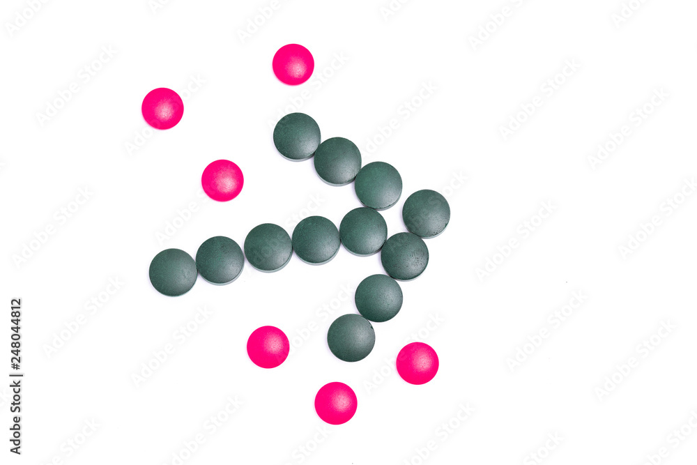 green and pink pills on white background green and pink pills on white background