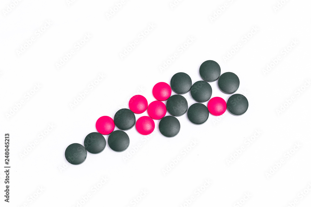 green and pink pills on white background green and pink pills on white background