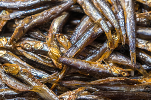 Cold smoked capelin fish background, smoked fish texture