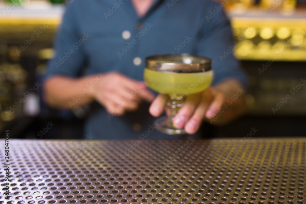 Green White Cocktail drink -beverage on a bar counter . Blurred Selective focus on the foreground glass, Top view . Trendy stylish edit . Copy paste space for design concept service barmen concept