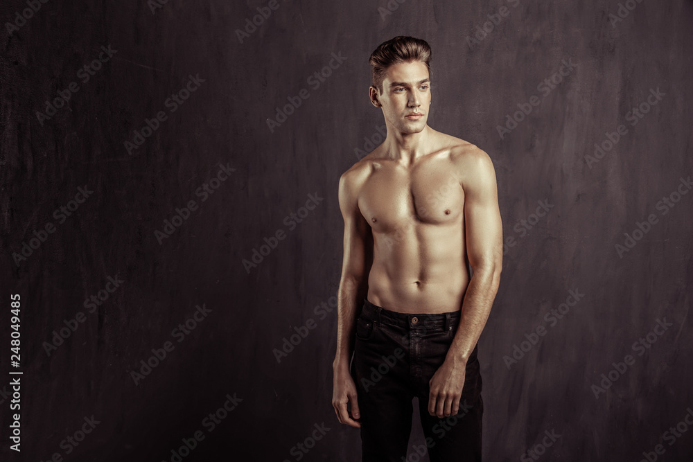 Fototapeta premium Handsome well built young man looking aside